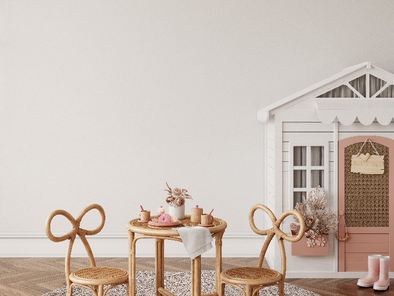 image of a minimalistic childrens play room with a white play house and a wooden tea set 